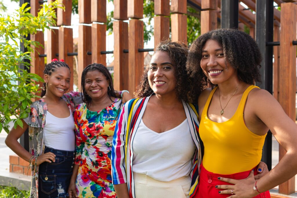 Joyful embrace between black women in the park